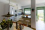 Dining area and kitchen with doors to terraces and annexe